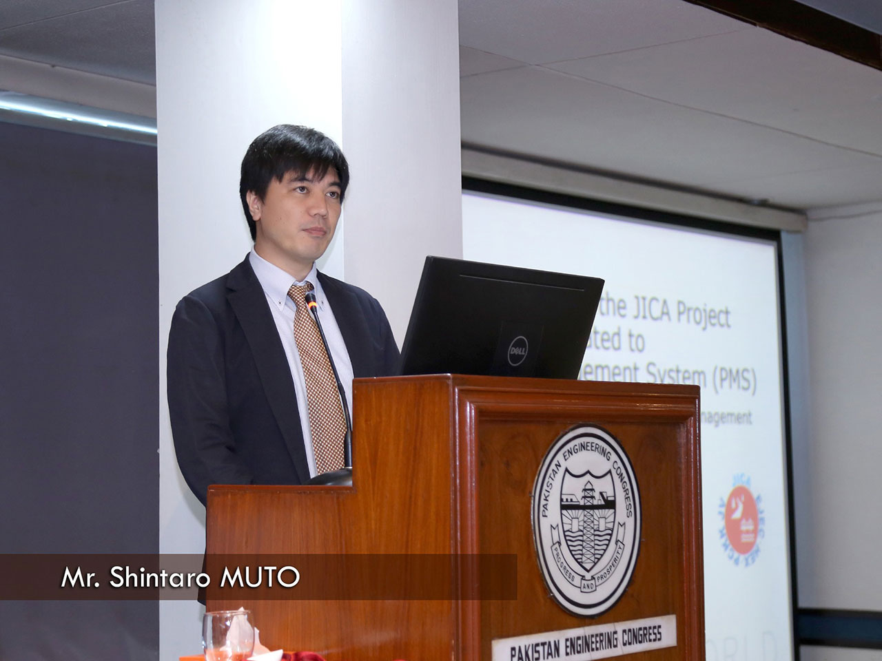 Muto giving a presentation at a seminar held by the local government